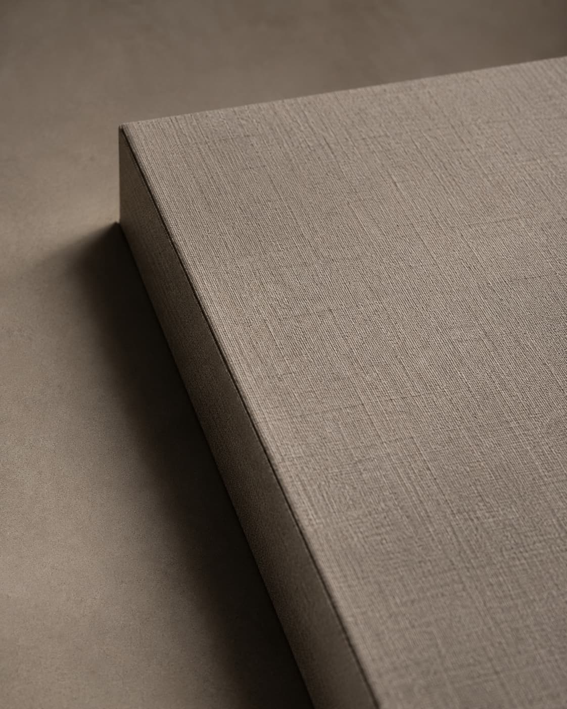 Rolled sheet of textured paper resting on flat sheets